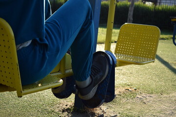 A dedicated young athlete puts in the hard work, vigorously training on gym equipment outdoors to...