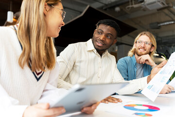 Diverse, multinational team analyzing financial data and business growth