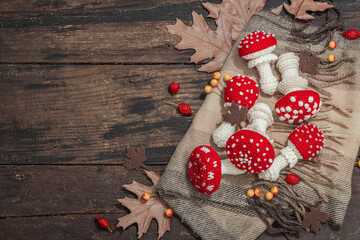 Autumn cozy mood composition. Crocheted amanita mushroom, handmade, fall hobby concept