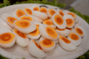 Halves of a boiled egg, a hard boiled egg cut in half on big dish at event