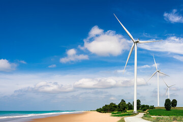Eclectic production by wind turbine at beach seaside with cloudy sky background	
