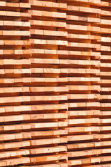 Stack of many small square wood bases are made from the old wooden pallets in vertical frame, recycling and reuse remaining wooden material used concept 