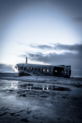 Fototapeta premium A man stands on a beach next to a large