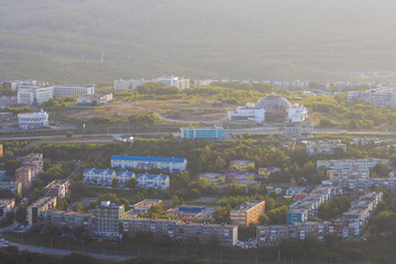 Morning cityscape. Top view of the buildings and streets of the city. Residential urban areas at sunrise. Beautiful aerial city landscape. Petropavlovsk-Kamchatsky, Kamchatka Krai, Far East of Russia.
