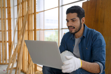 Carpenter is working at woodshop.