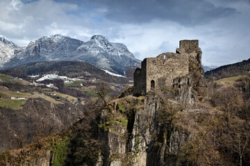 Collepietra: the medieval ruins of Steinegg castle and in the background the Catinaccio dolomite range. South Tyrol, Italy.