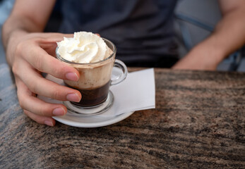 Vienna, Austria, August 18, 2022. Nice shot of a Viennese specialty: coffee with cream. Hand grabs...