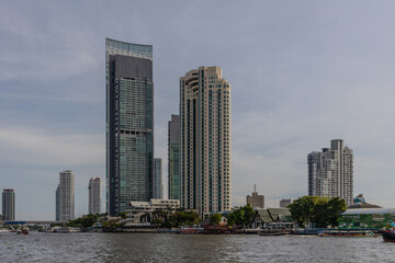Fototapeta premium Wednesday 26 June 2024 BKK high rise towers building residential apartments and commercial buildings on Chao Phraya River Bangkok Thailand