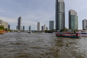 Fototapeta premium Wednesday 26 June 2024 BKK high rise towers building residential apartments and commercial buildings on Chao Phraya River Bangkok Thailand