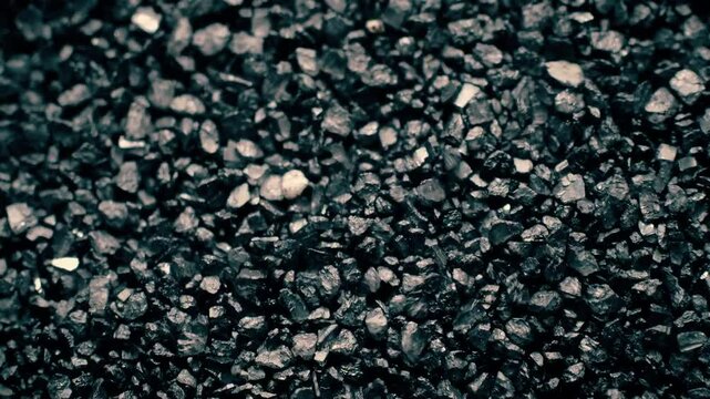 Close-up of a black sand surface moving.