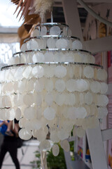 Openwork hanging chandeliers in a summer cafe in nature. Design of street lamps