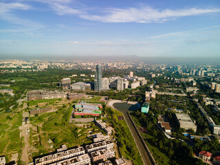 Obraz premium The tallest building in the city of Almaty from above, Aerial photography from a drone of the city's architecture. Great view of Esentai Mall and the Ritz Carlton Hotel. 