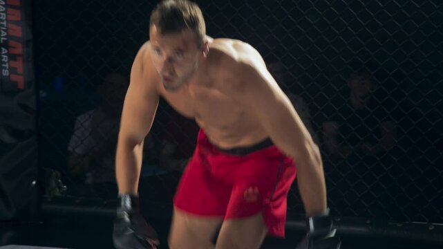 MMA Match: Fight Erupts with Explosive Energy as Two Strong Caucasian Men Exchange Rapid Strikes and Wrestle for Control. Audience Treated with a Thrilling Spectacle of Ground and Pound