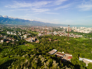 Fototapeta premium Aerial photography of the city of Almaty with a view of the mountains.