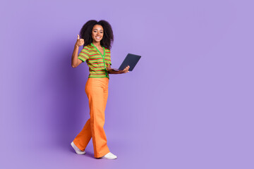 Full length photo of cheerful pretty lady dressed striped cardigan showing thumb up typing gadget empty space isolated purple color background