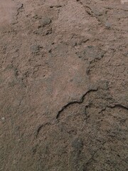 Broken fractured brown stone with a crack in it background, damaged grey uneven disrupted cracked floor