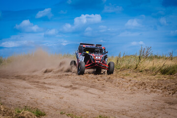 Obraz premium UTV buggy and 4x4 offroad in sandy track. Rally extreme riding