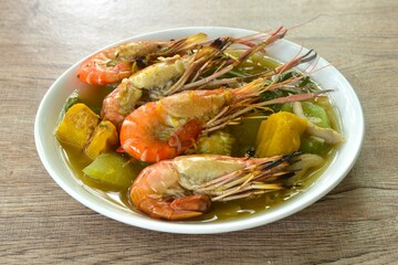 boiled spicy mixed vegetable topping grilled river shrimp soup on plate