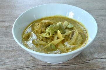 spicy boiled slice fresh bamboo shoot with chicken topping stink bean in coconut milk curry soup on...