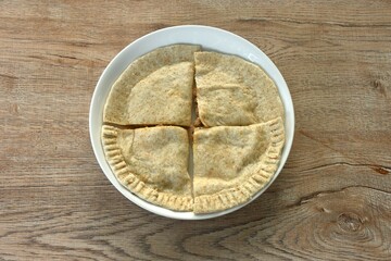 Quesadilla Mexican pizza stuffing mashed spicy chicken with cheese and salsa sauce on plate