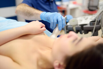 Mammologist doctor examines a woman breasts and lymph nodes using ultrasound. Mammography and...