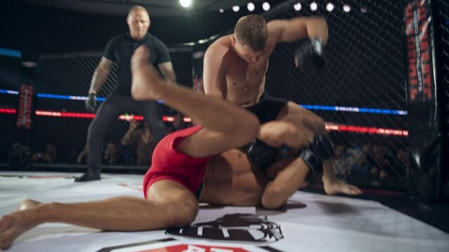 Mixed Martial Artists Having a Fierce Middleweight Battle Inside an Octagon Ring. Successful Fighter Throwing the Opponent Over His Back, Delivering Finishing Blows and Getting the Win