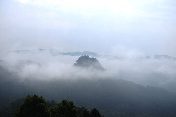 Beautiful sunrise in morning sky with mist and foggy in valley of layer mountain in natural and travel destination in tropical rain forest