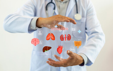Concept of organ donation and transplantation, doctor holds with virtual icons of various human...