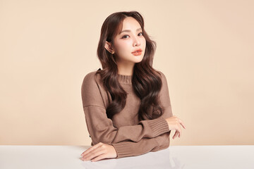 Naklejka premium Beautiful young asian woman with clean fresh skin on beige background, Face care, Facial treatment, Cosmetology, beauty and spa, Asian women portrait.