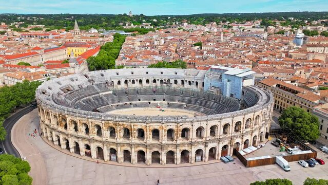 Aerial view of Imposing Roman amphitheatre hosting historic reconstructions in Nimes, France. View from above Amphitheatre of N&icirc;mes and Museum Romanit&eacute; in France.