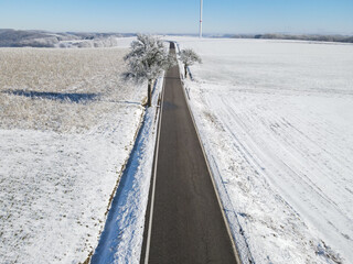 Obraz premium View from above of a country road in winter