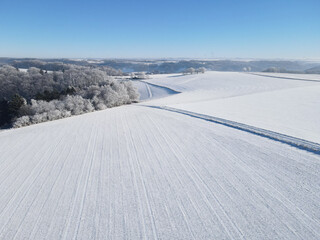 Aerial view of farm fields with snow in winter 