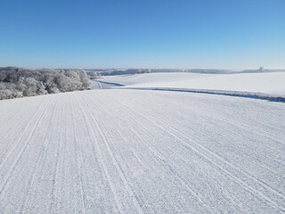 Aerial view of a farm fields with snow in winter 