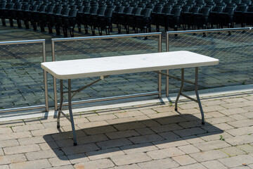 table in the sun outside a live entertainment venue