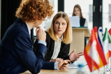 Two teenagers in suits participate in a Model UN conference.
