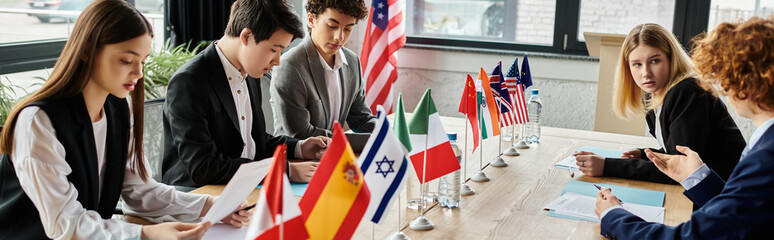 Teenagers participate in a Model United Nations event, debating global issues.