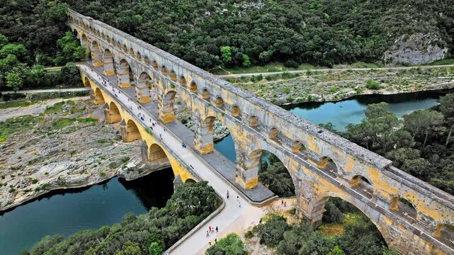 Aerial view of the aqueduct bridge with arched tiers in France. Drone view of Pont du Gard the highest Roman aqueduct bridge in the world.