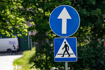 Blue Traffic Signs for Pedestrian Crossing and Straight Ahead Traffic on a Street