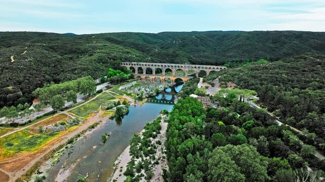 Aerial view of the aqueduct bridge with arched tiers in France. Drone view of Pont du Gard the highest Roman aqueduct bridge in the world.