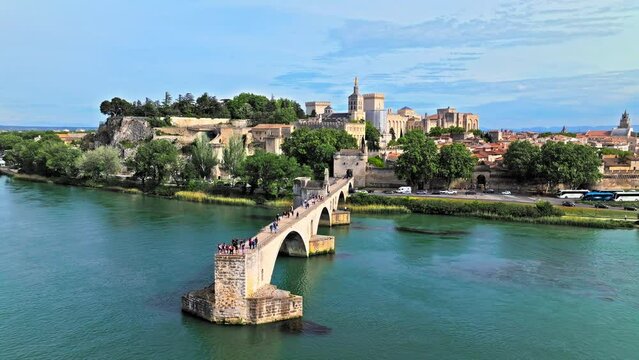 Aerial view of ruins of medieval bridge, with 4 arches spanning the Rhone and a small chapel. Pont Saint-B&eacute;nezet bridge in France.