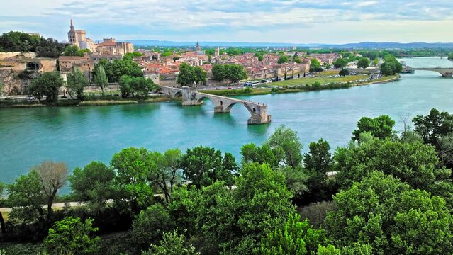 Aerial view of ruins of medieval bridge, with 4 arches spanning the Rhone and a small chapel. Pont Saint-B&eacute;nezet bridge in France.