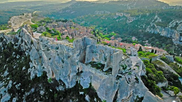 Aerial view of Medieval fortress ruins with replica siege engines in France. Les Baux de Provence village is on the rock formation, and its castle Ch&acirc;teau des Baux-de-Provence in France.