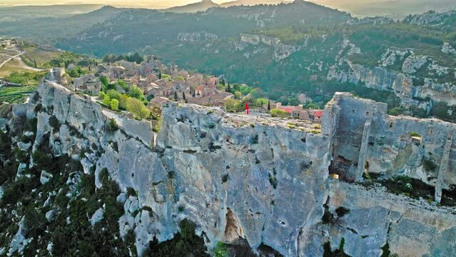 Aerial view of Medieval fortress ruins with replica siege engines in France. Les Baux de Provence village is on the rock formation, and its castle Ch&acirc;teau des Baux-de-Provence in France.