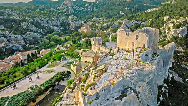 Aerial view of Medieval fortress ruins with replica siege engines in France. Les Baux de Provence village is on the rock formation, and its castle Ch&acirc;teau des Baux-de-Provence in France.