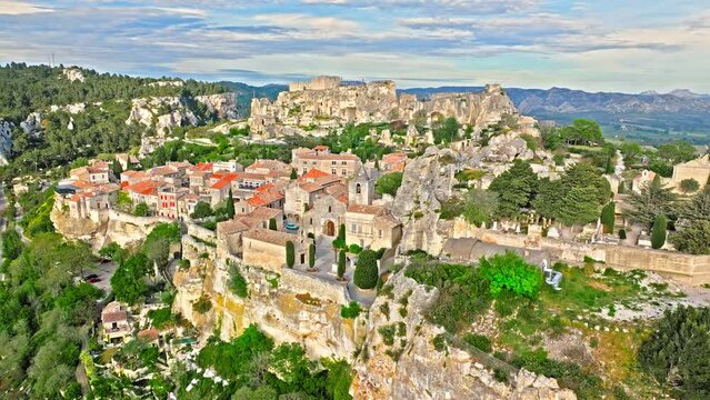 Aerial view of Medieval fortress ruins with replica siege engines in France. Les Baux de Provence village is on the rock formation, and its castle Ch&acirc;teau des Baux-de-Provence in France.