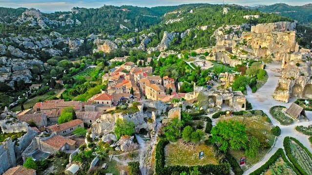 Aerial view of Medieval fortress ruins with replica siege engines in France. Les Baux de Provence village is on the rock formation, and its castle Ch&acirc;teau des Baux-de-Provence in France.