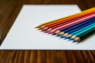 Obraz premium A bunch of colored pencils are arranged on a sheet of white paper