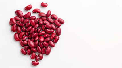 Red kidney beans arranged in a heart shape on a white background.