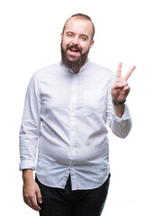 Naklejka premium Young caucasian hipster man over isolated background smiling with happy face winking at the camera doing victory sign. Number two.
