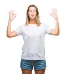 Young beautiful woman over isolated background relax and smiling with eyes closed doing meditation gesture with fingers. Yoga concept.